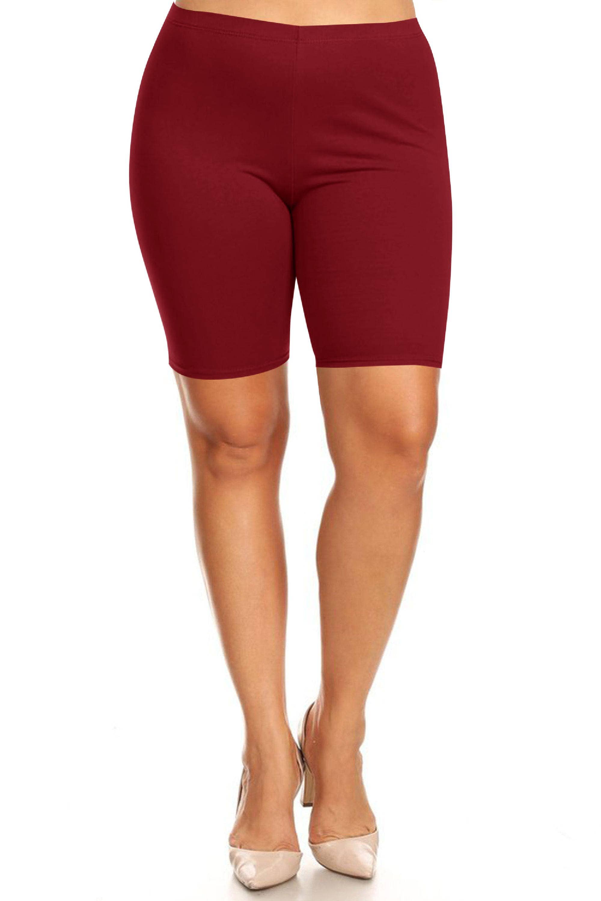 Maroon bike shorts worn by a person on a white background