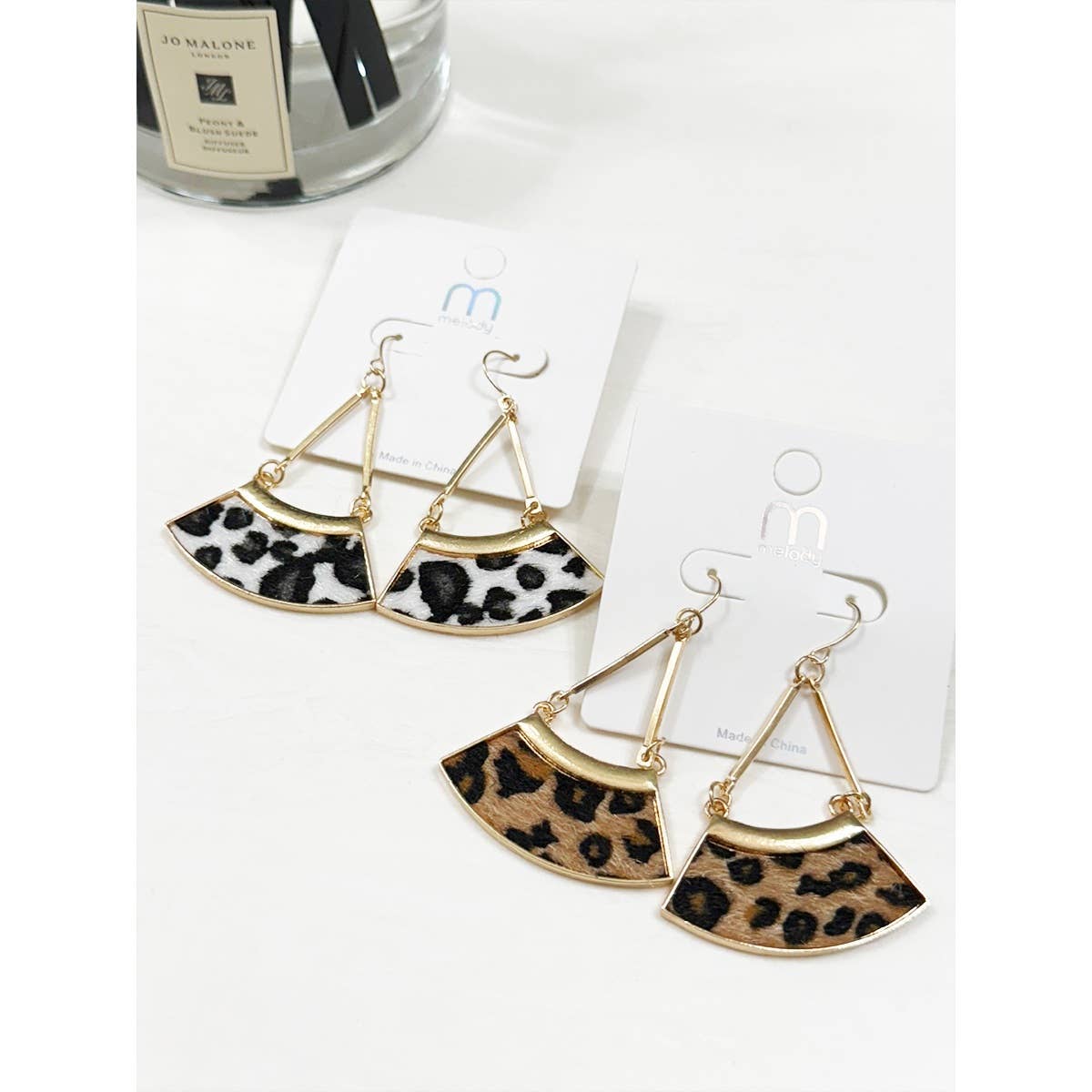 Leopard print earrings on white background