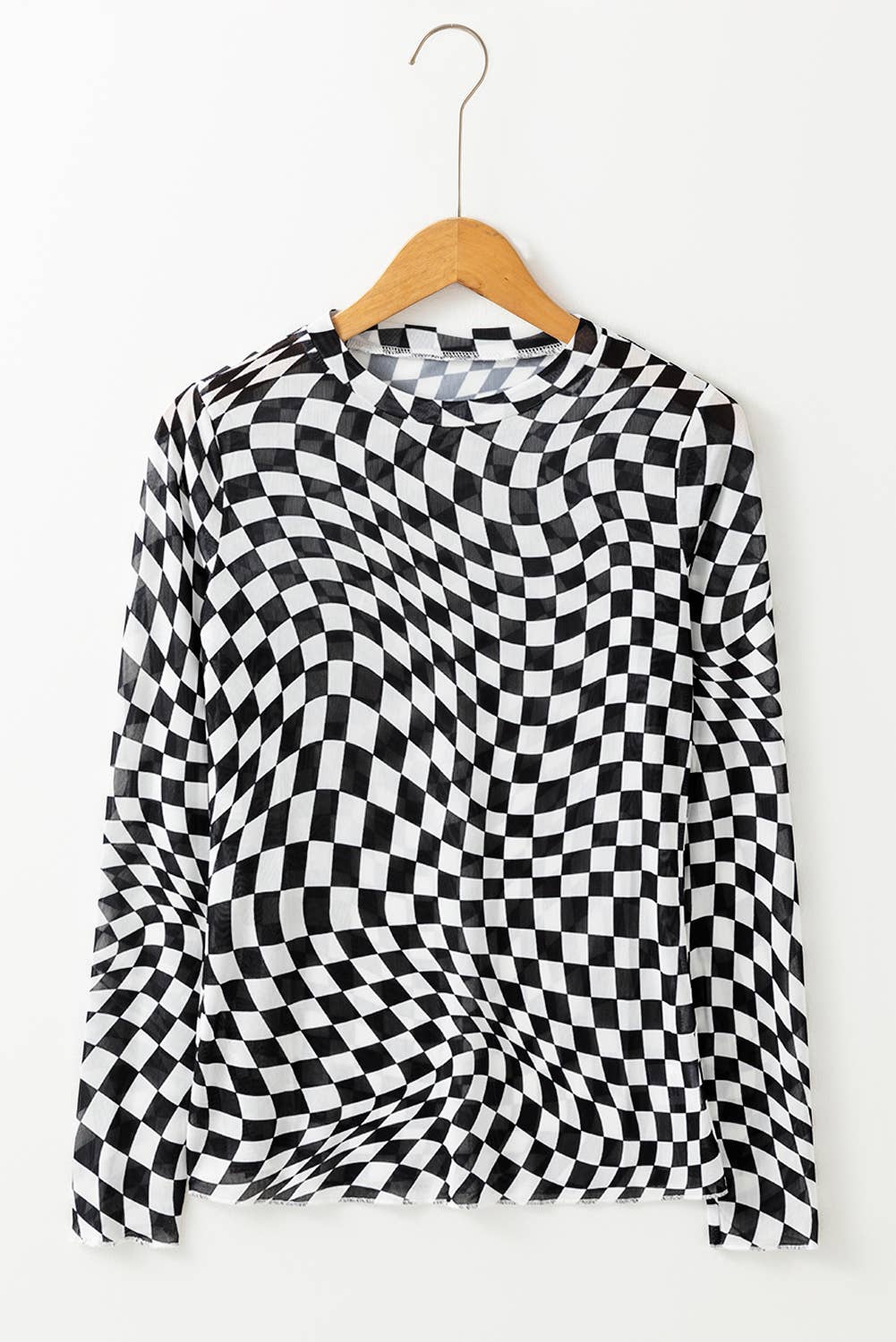 Black and white checkered shirt on a hanger against a white background