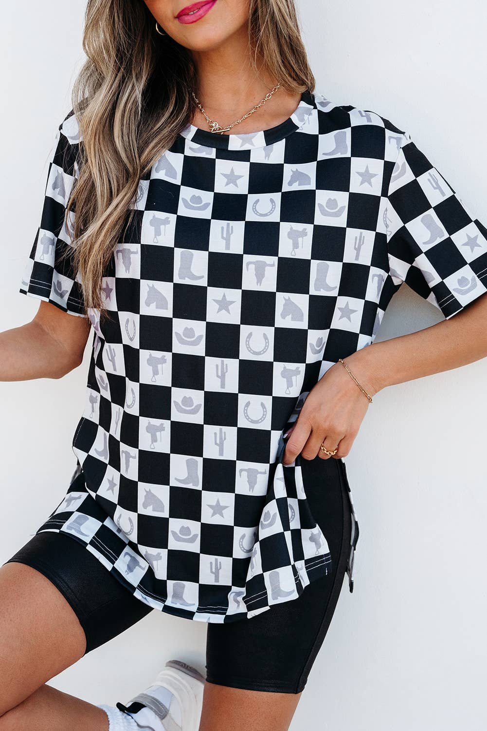 Person wearing a black and white checkered shirt with small prints on a white background