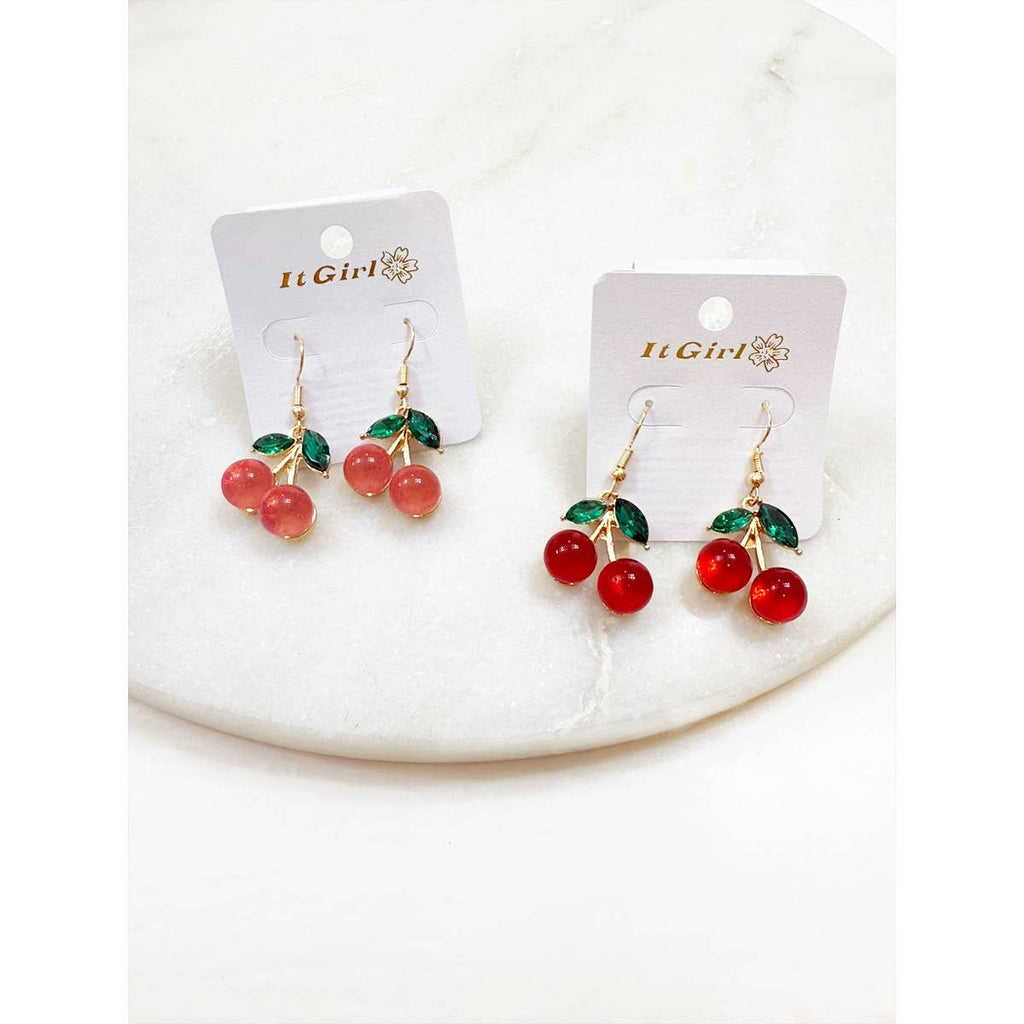 Cherry-themed earrings on 'It Girl' branded cards against a white background