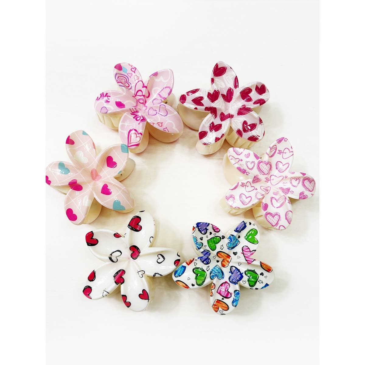 Set of decorative flowers with colorful heart patterns on a white background