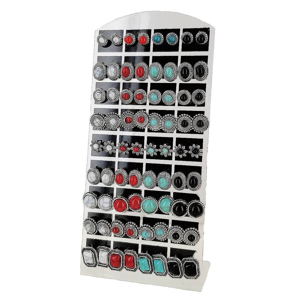 Earring display rack with various earrings on a white background