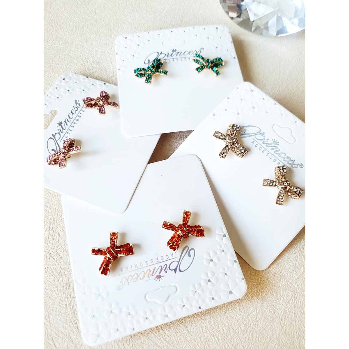 Set of earrings on branded cards with a textured surface background